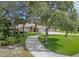 Beautiful brick home with a curved driveway, mature trees, and a well-maintained lawn at 1879 Odham Dr, Deltona, FL 32738