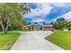Charming single-story brick home with a two-car garage and well-manicured lawn at 1879 Odham Dr, Deltona, FL 32738