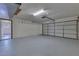 Clean garage features painted floors, overhead lighting, and garage door opener at 1879 Odham Dr, Deltona, FL 32738