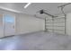 Clean garage features painted floors, overhead lighting, and a side entry door at 1879 Odham Dr, Deltona, FL 32738