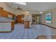 Open-concept kitchen with granite countertops, island, and vaulted ceiling at 1879 Odham Dr, Deltona, FL 32738