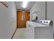 Laundry room with washer, dryer, closet, utility sink, and patterned vinyl flooring at 1879 Odham Dr, Deltona, FL 32738