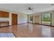 Bright living room with hardwood floors, large windows, and a ceiling fan at 1879 Odham Dr, Deltona, FL 32738