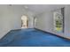 Comfortable living room with blue carpet, archway, and natural light from multiple windows at 1879 Odham Dr, Deltona, FL 32738
