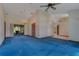 Spacious living room with blue carpet, chandelier, and sliding glass doors leading to outdoor space at 1879 Odham Dr, Deltona, FL 32738