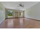 Bright living room featuring wood floors, two large windows, and a ceiling fan at 1879 Odham Dr, Deltona, FL 32738