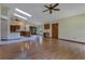 Open-concept living room boasts skylights, wood floors, and a ceiling fan at 1879 Odham Dr, Deltona, FL 32738