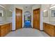 Bathroom featuring double vanities, a tile floor, and an arched entryway leading to another room at 1879 Odham Dr, Deltona, FL 32738