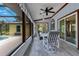 Enclosed patio featuring a ceiling fan, tile floor, and comfortable seating area at 1879 Odham Dr, Deltona, FL 32738