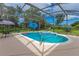 Relaxing screened-in pool and patio with umbrellas, hot tub, and tropical garden views at 1879 Odham Dr, Deltona, FL 32738