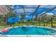 Relaxing pool area with hot tub, umbrellas, and screened-in enclosure at 1879 Odham Dr, Deltona, FL 32738
