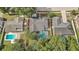 An aerial view displays neighboring homes, each featuring a private pool and manicured landscaping at 1921 Heathwood Dr, Winter Park, FL 32792