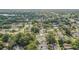 An aerial view of a neighborhood with mature trees and glimpses of a lake in the distance at 1921 Heathwood Dr, Winter Park, FL 32792