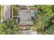 A birds-eye view of a home with a screened pool and a quaint patio at 1921 Heathwood Dr, Winter Park, FL 32792