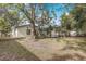 Lovely backyard shows mature landscaping, a screened in pool, and a tranquil spot to unwind at 1921 Heathwood Dr, Winter Park, FL 32792