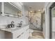 This bathroom boasts a dual vanity and shower with marble style tile and modern fixtures at 1921 Heathwood Dr, Winter Park, FL 32792