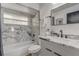 Bathroom with a marble-look tile shower/tub combination and a marble vanity top at 1921 Heathwood Dr, Winter Park, FL 32792