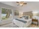 Well-lit bedroom featuring a large window and a comfortable bed with stylish decor at 1921 Heathwood Dr, Winter Park, FL 32792