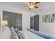Bedroom featuring modern gray closet doors, neutral walls, and a ceiling fan at 1921 Heathwood Dr, Winter Park, FL 32792