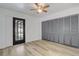 Bright bedroom with a ceiling fan, light wood flooring and a door to an outdoor patio at 1921 Heathwood Dr, Winter Park, FL 32792