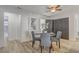 Airy dining area with gray accent chairs and decor including abstract artwork and a ceiling fan at 1921 Heathwood Dr, Winter Park, FL 32792