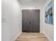 Bright entryway featuring double doors, hardwood flooring, and modern decor at 1921 Heathwood Dr, Winter Park, FL 32792