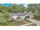 An exterior view of a single-Gathering home showcasing a well-maintained lawn and driveway at 1921 Heathwood Dr, Winter Park, FL 32792