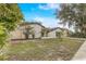 Exterior shot highlights the home's side yard, complemented by lush landscaping at 1921 Heathwood Dr, Winter Park, FL 32792