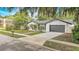 An exterior view of a single-Gathering home featuring a two-car garage, lawn, and mailbox at 1921 Heathwood Dr, Winter Park, FL 32792