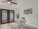 Bright office with glass doors leading to the outdoors, desk and chair and decorative rug and wall art at 1921 Heathwood Dr, Winter Park, FL 32792