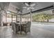 Screened outdoor dining area with a table, chairs, and ceiling fans, offering a relaxing poolside setting at 1921 Heathwood Dr, Winter Park, FL 32792