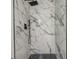 Modern shower featuring marble-look tile and black fixtures with a mosaic tile floor at 1921 Heathwood Dr, Winter Park, FL 32792