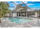 Beautiful screened-in pool with ample deck space, surrounded by lush landscaping, ideal for relaxation and recreation at 1921 Heathwood Dr, Winter Park, FL 32792