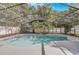 Private screened-in pool surrounded by mature trees and landscaping, offering a tranquil backyard retreat at 1921 Heathwood Dr, Winter Park, FL 32792