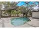 Inviting screened-in pool amidst mature trees and verdant landscaping, perfect for swimming and enjoying outdoor living at 1921 Heathwood Dr, Winter Park, FL 32792