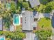 Aerial view of the home, lush backyard, pool, landscaping, and roof at 1926 Natalen Rd, Winter Park, FL 32792