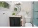 Bathroom with modern fixtures, wainscoting detail, and a glass-enclosed shower and bathtub at 1926 Natalen Rd, Winter Park, FL 32792