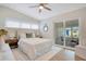 Bright bedroom with a ceiling fan, a neutral color palette, and sliding glass doors to the patio at 1926 Natalen Rd, Winter Park, FL 32792