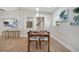 Bright dining room featuring a modern table and chairs, wood floors, and views into the kitchen at 1926 Natalen Rd, Winter Park, FL 32792