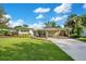 Charming single-story home with well-manicured lawn, covered carport, and inviting curb appeal at 1926 Natalen Rd, Winter Park, FL 32792