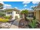 Inviting front exterior featuring a well-maintained walkway, lush landscaping and a stylish blue front door at 1926 Natalen Rd, Winter Park, FL 32792