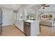 Modern kitchen with stainless steel appliances, white cabinets, and an open design leading to the living area at 1926 Natalen Rd, Winter Park, FL 32792