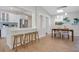 Open floor plan displaying a sleek kitchen with modern finishes and seamlessly connected dining and living areas at 1926 Natalen Rd, Winter Park, FL 32792