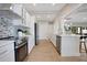 Spacious kitchen featuring stainless steel appliances, white cabinetry, and an island with sink and breakfast bar at 1926 Natalen Rd, Winter Park, FL 32792