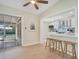Open-concept kitchen featuring white cabinets, a breakfast bar, and stainless steel appliances at 1926 Natalen Rd, Winter Park, FL 32792