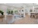 Inviting living room featuring stylish furnishings, light wood floors, and seamless flow to outdoor entertainment at 1926 Natalen Rd, Winter Park, FL 32792