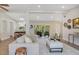 Well-lit seating area with cozy armchairs, a small side table, and sleek, easy-to-maintain wood flooring at 1926 Natalen Rd, Winter Park, FL 32792