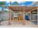 Outdoor kitchen with grill, bench, and storage in fenced backyard at 1926 Natalen Rd, Winter Park, FL 32792
