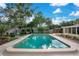 Backyard pool surrounded by lush green grass and a wooden fence at 1926 Natalen Rd, Winter Park, FL 32792