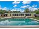 Backyard view showcasing the in-ground pool, lanai, and landscaping at 1926 Natalen Rd, Winter Park, FL 32792
